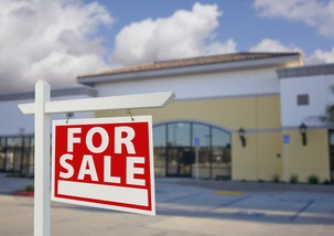 vacant-retail-building-with-for-sale-real-estate-sign.jpg